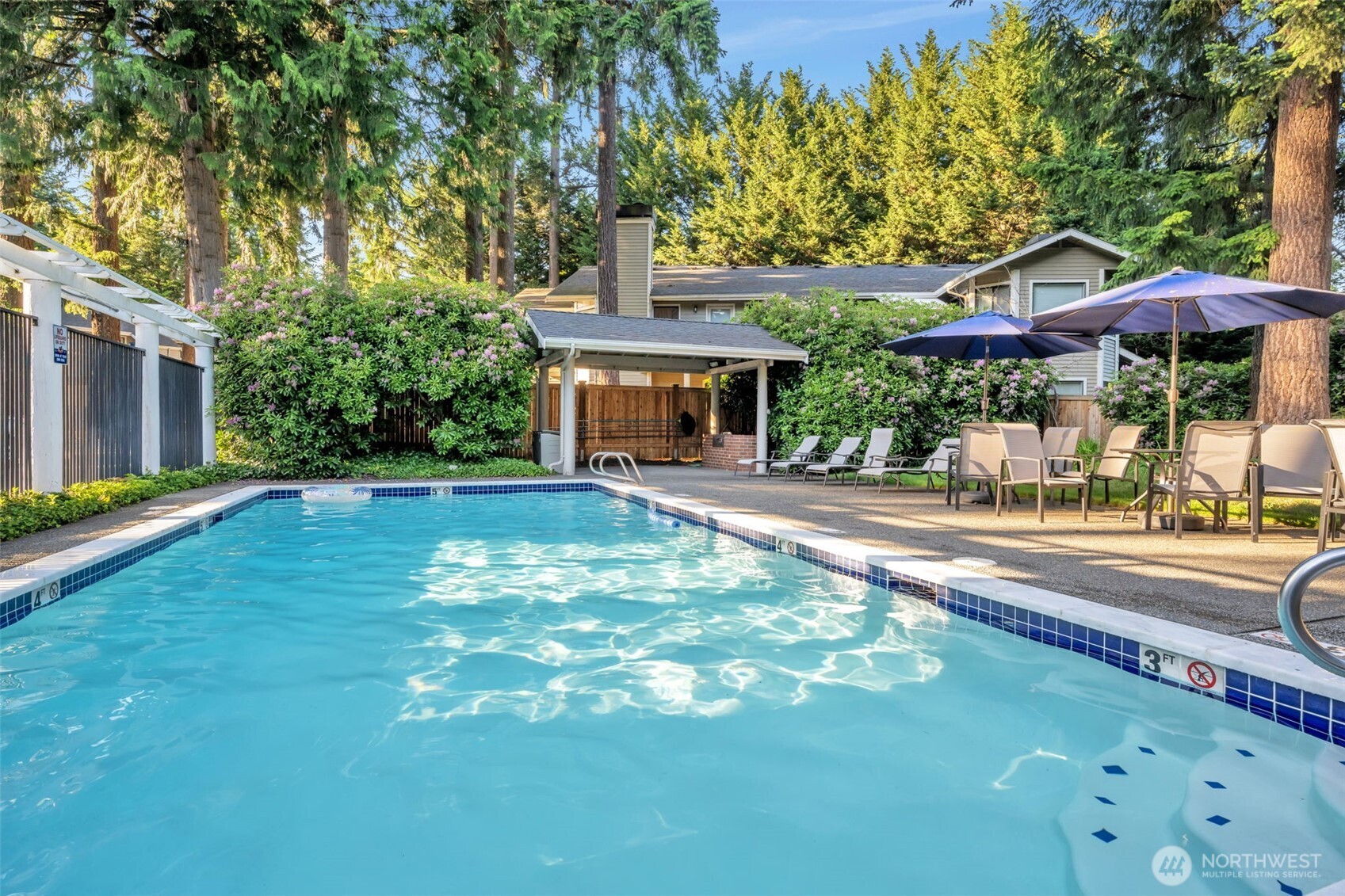 9009 Avondale Road Northeast, Unit D107 Redmond, WA 98052 - Photo 29 of 34 a view of a patio with table and chairs under an umbrella