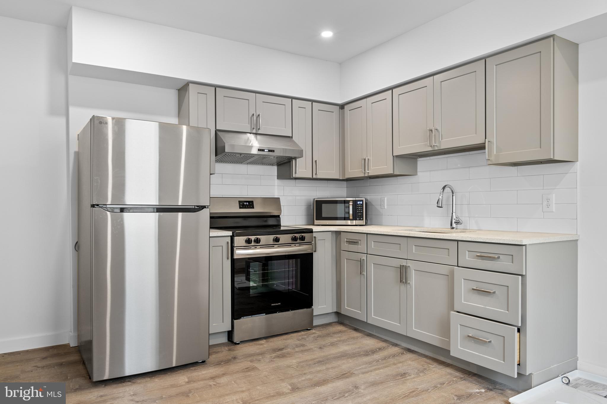 a kitchen with cabinets stainless steel appliances and a sink