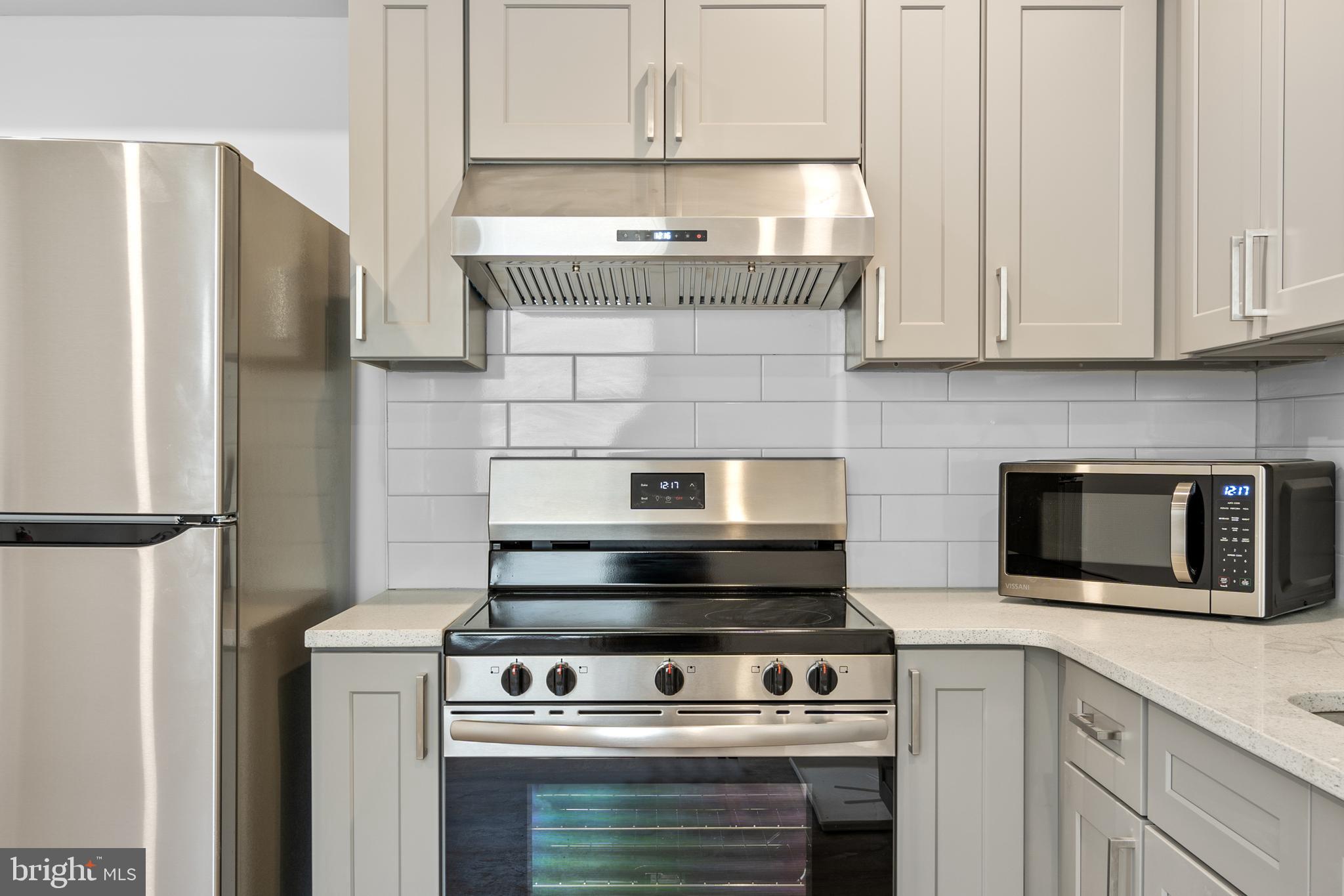 2652 Bridge Street Philadelphia, PA 19137 - Photo 2 of 31 a stove top oven sitting inside of a kitchen