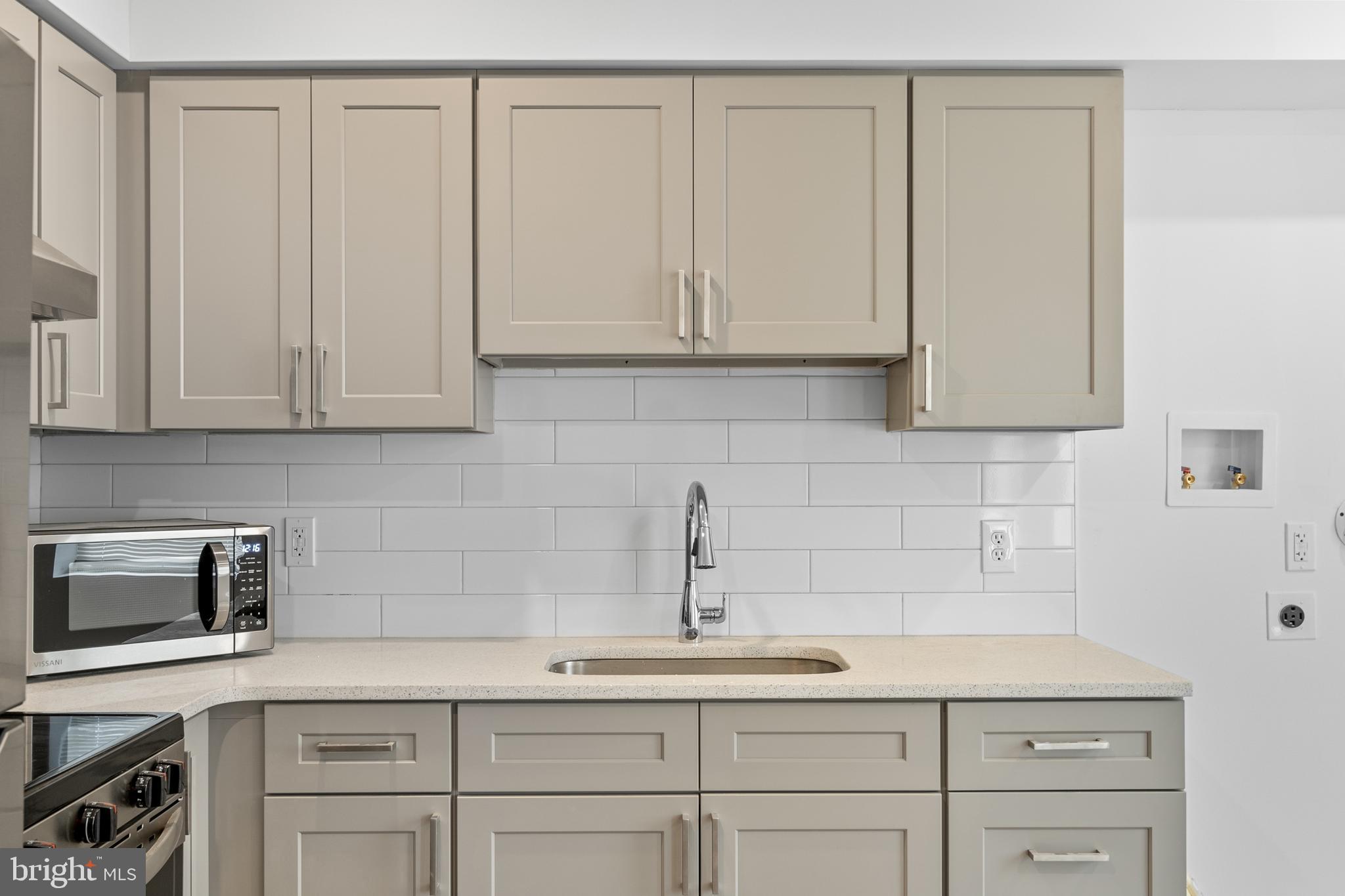 2652 Bridge Street Philadelphia, PA 19137 - Photo 3 of 31 a kitchen with white cabinets and sink