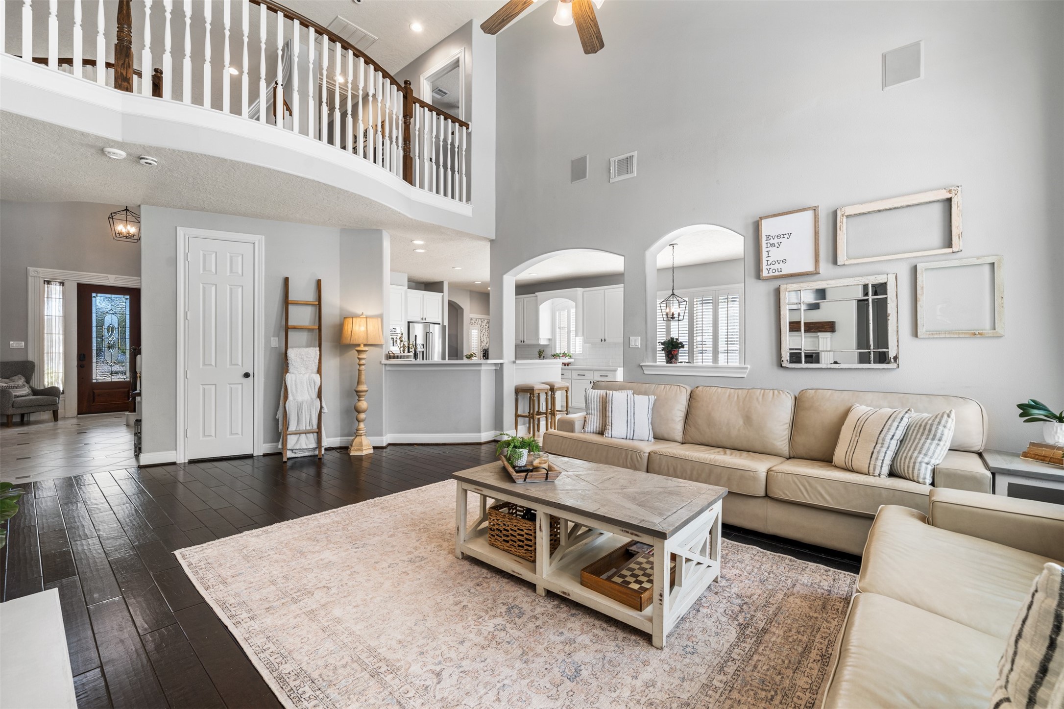 28446 Shining Creek Lane Spring, TX 77386 - Photo 11 of 47 a living room with furniture kitchen view and a wooden floor