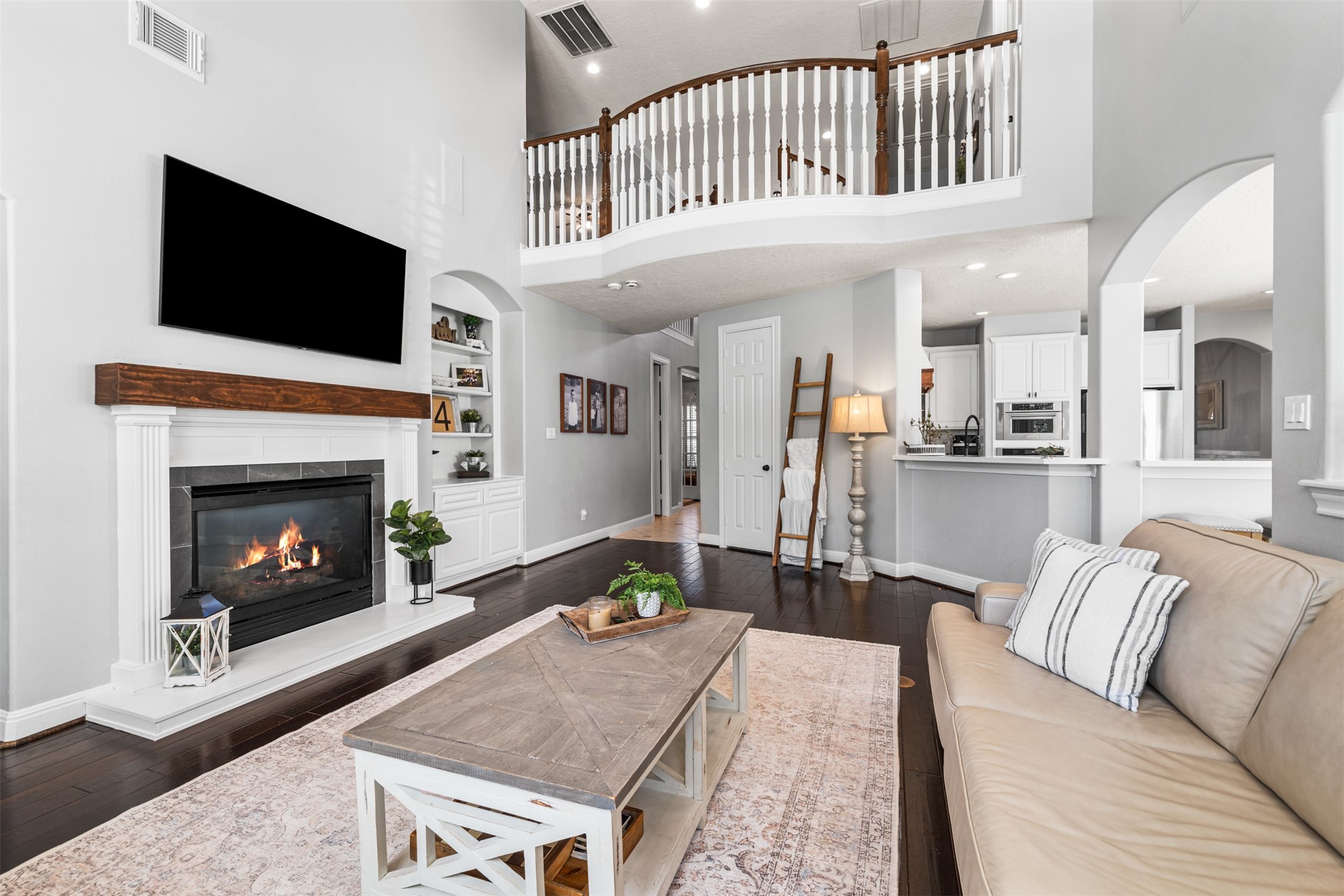 28446 Shining Creek Lane Spring, TX 77386 - Photo 13 of 47 a living room with furniture a flat screen tv and a fireplace