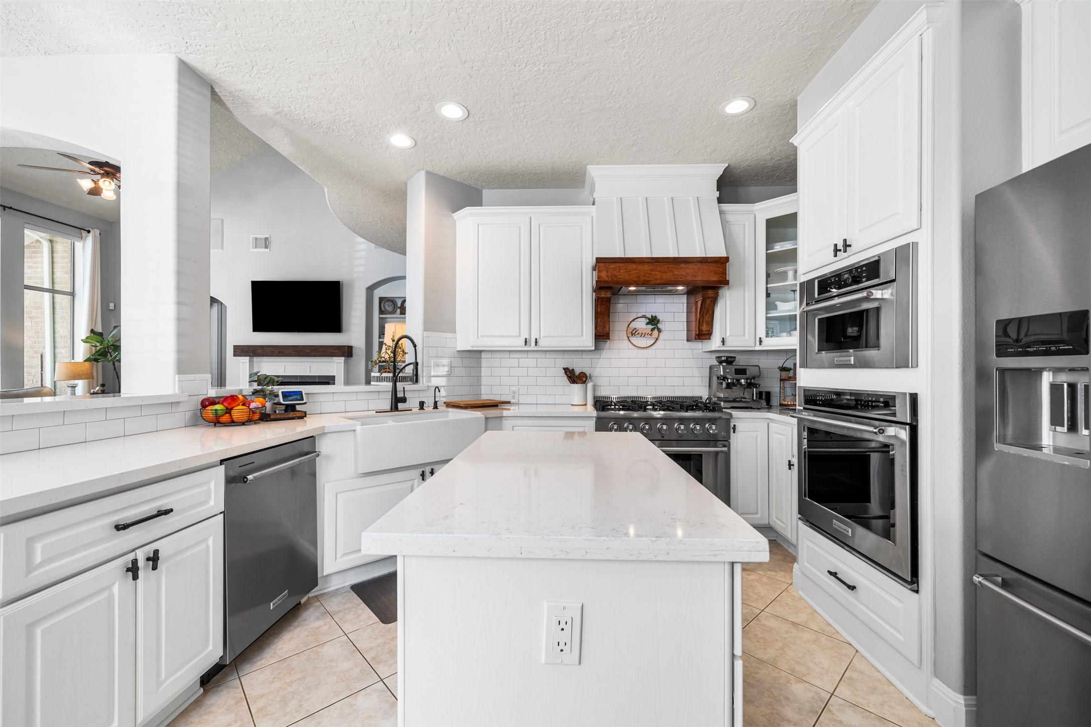 28446 Shining Creek Lane Spring, TX 77386 - Photo 15 of 47 a kitchen with stainless steel appliances a stove sink microwave and refrigerator