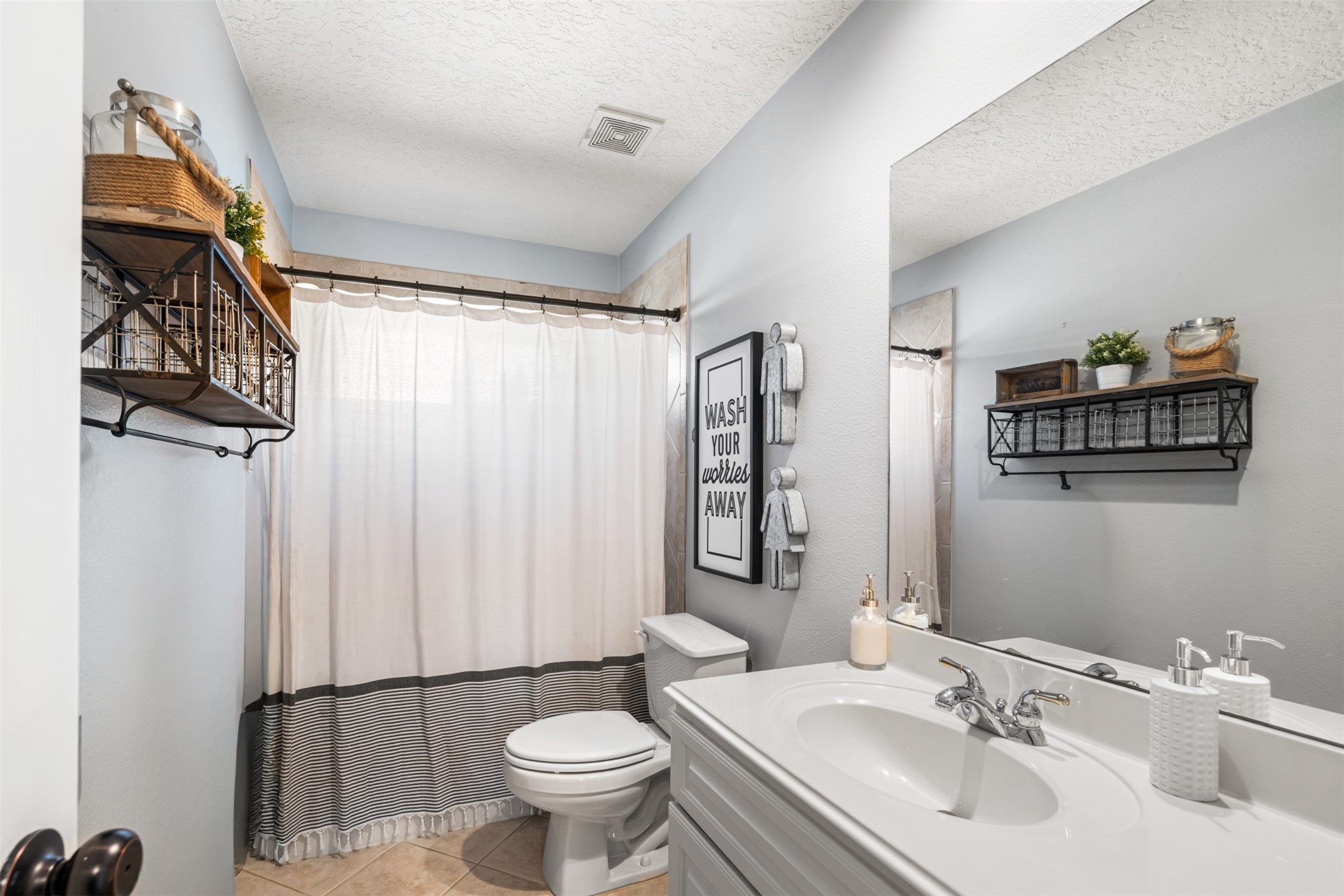 28446 Shining Creek Lane Spring, TX 77386 - Photo 32 of 47 a bathroom with a toilet a sink and a mirror