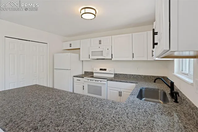 a kitchen with a sink stove and refrigerator