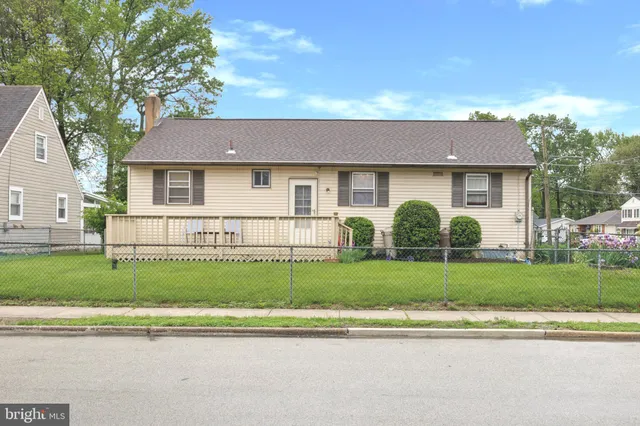a front view of a house with a garden and plants
