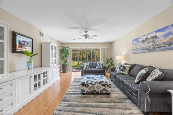 a living room with furniture and a large window