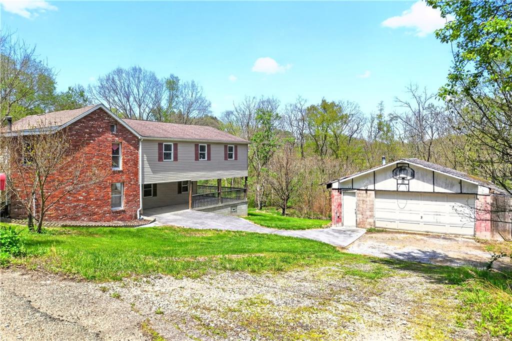 116 Dutchtown Road Herminie, PA 15637 - Photo 2 of 49 a front view of a house with a yard and garage