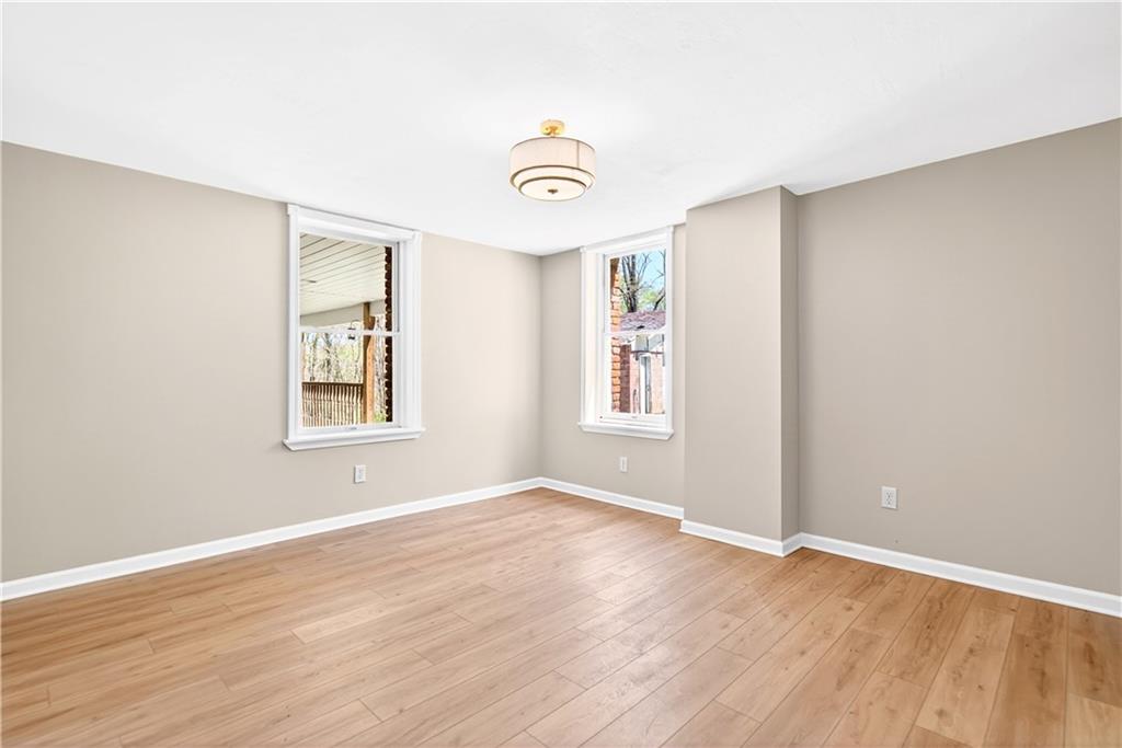 116 Dutchtown Road Herminie, PA 15637 - Photo 22 of 49 a view of an empty room with wooden floor and a window
