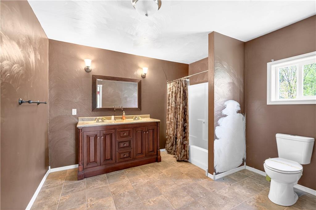 116 Dutchtown Road Herminie, PA 15637 - Photo 28 of 49 a spacious bathroom with a granite countertop sink and a mirror