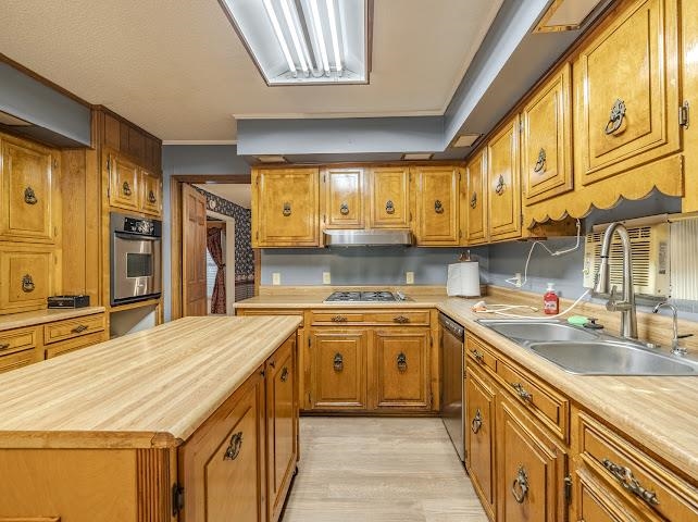 660 Hinton Road Counce, TN 38326 - Photo 8 of 40 Kitchen featuring extensive wood cabinetry, wood-finish countertops, and a built-in oven