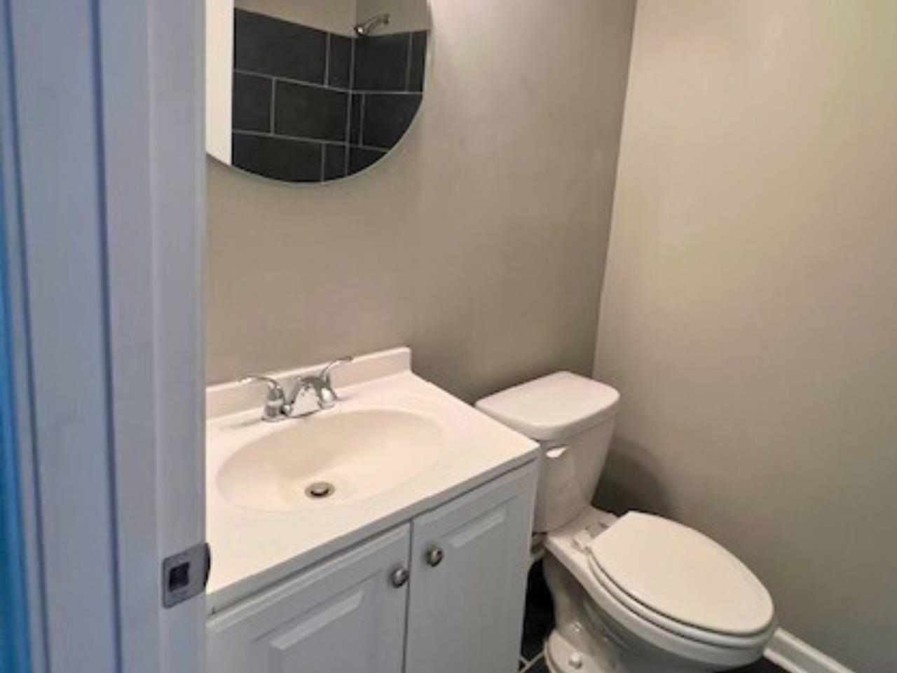 4710 Hillbrook Road Memphis, TN 38109 - Photo 5 of 11 a white toilet sitting next to a bathroom sink