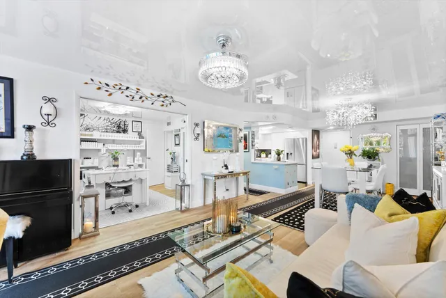 a living room with furniture and a chandelier