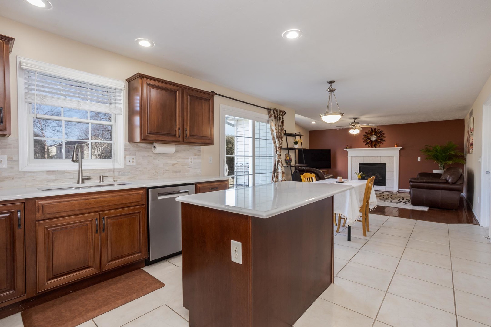 2884 Three Eagles Street Normal, IL 61761 - Photo 11 of 48 a kitchen with stainless steel appliances granite countertop a sink counter space cabinets and a large window