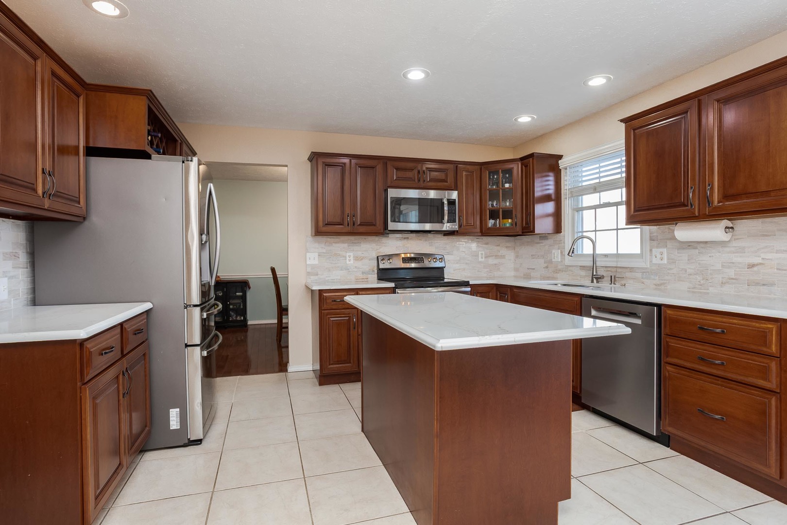 2884 Three Eagles Street Normal, IL 61761 - Photo 12 of 48 a kitchen with stainless steel appliances granite countertop a sink stove and refrigerator
