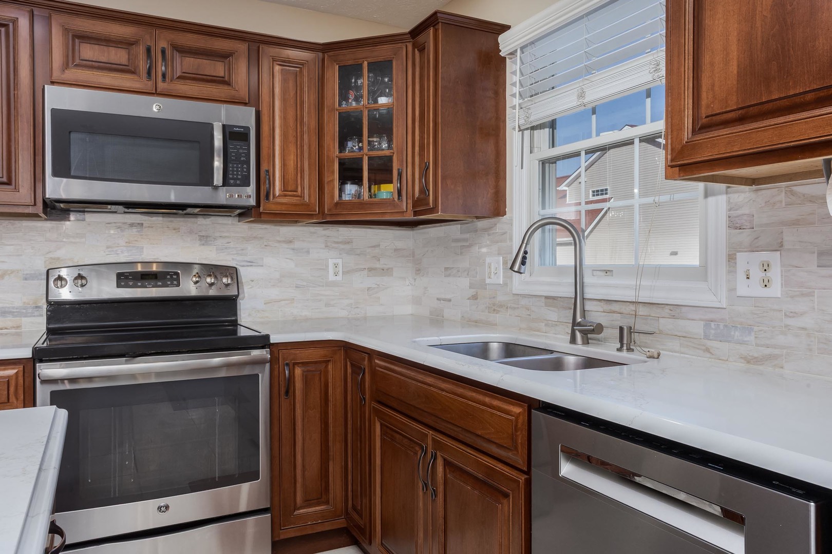 2884 Three Eagles Street Normal, IL 61761 - Photo 14 of 48 a kitchen with stainless steel appliances a stove microwave and sink