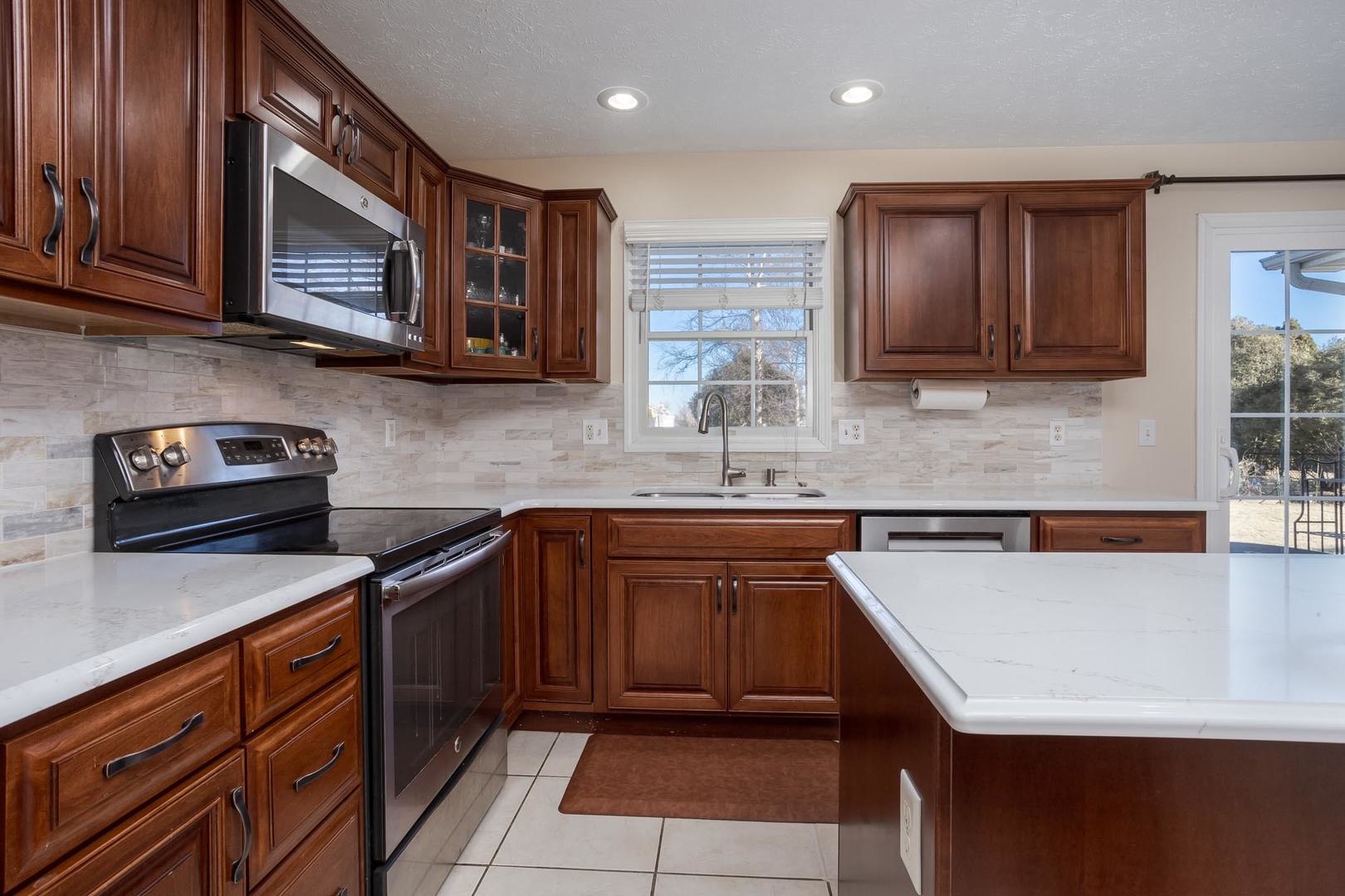 2884 Three Eagles Street Normal, IL 61761 - Photo 15 of 48 a kitchen with stainless steel appliances granite countertop a sink wooden cabinets and granite counter tops
