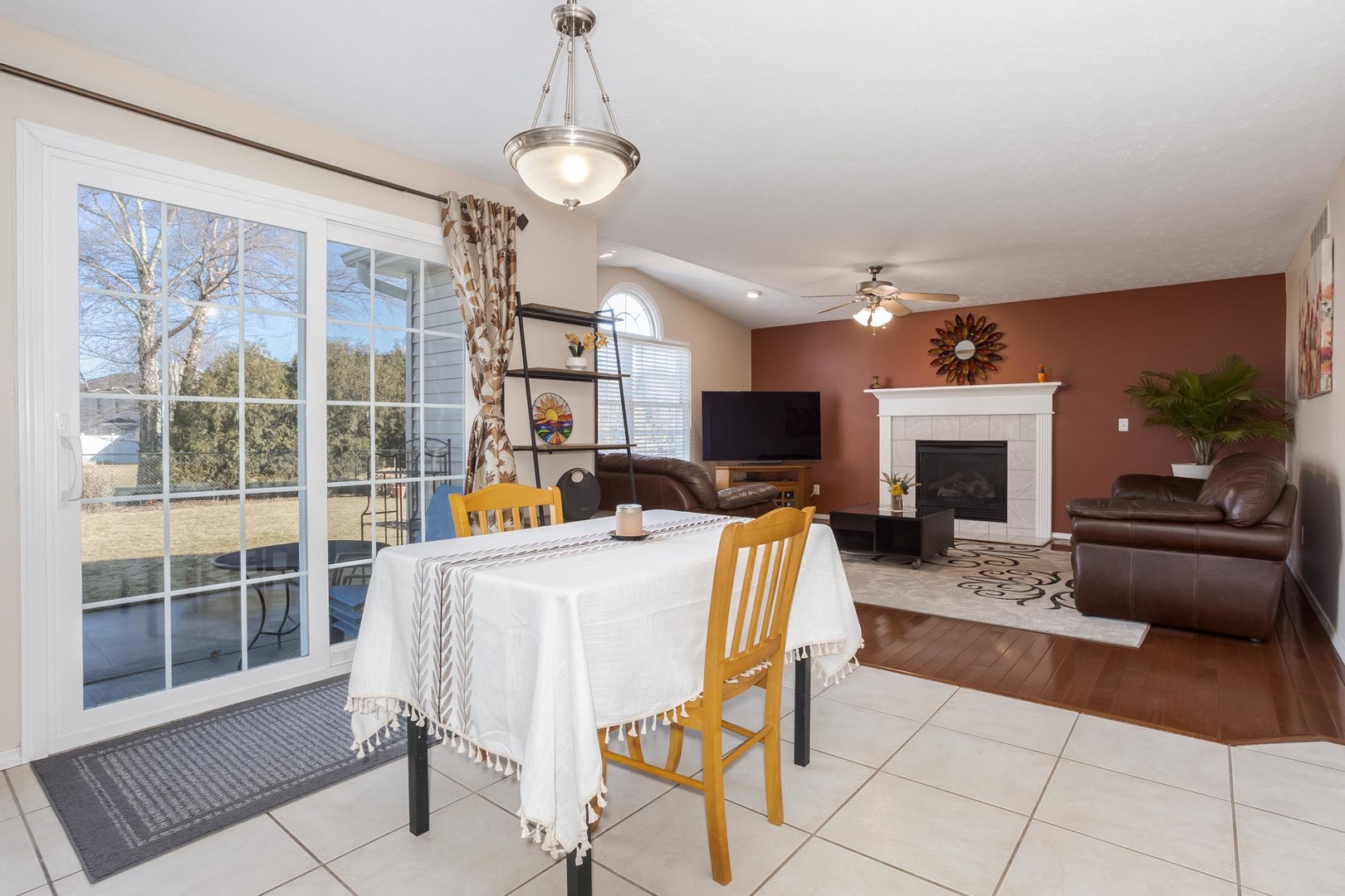 2884 Three Eagles Street Normal, IL 61761 - Photo 17 of 48 a living room with furniture a fireplace and a table