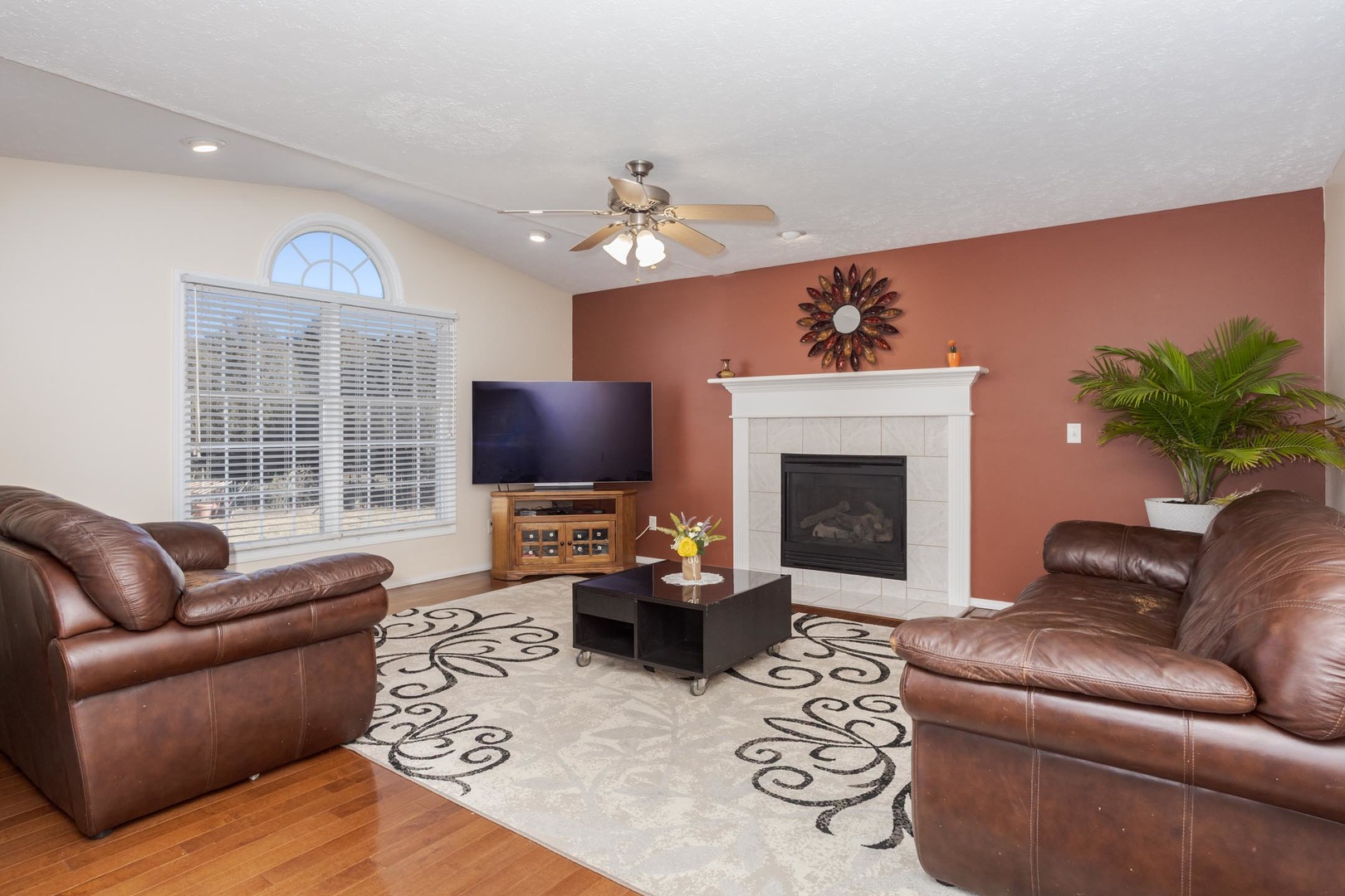 2884 Three Eagles Street Normal, IL 61761 - Photo 19 of 48 a living room with furniture a fireplace and a flat screen tv
