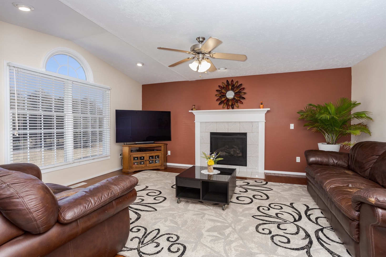 2884 Three Eagles Street Normal, IL 61761 - Photo 20 of 48 a living room with furniture a fireplace and a flat screen tv