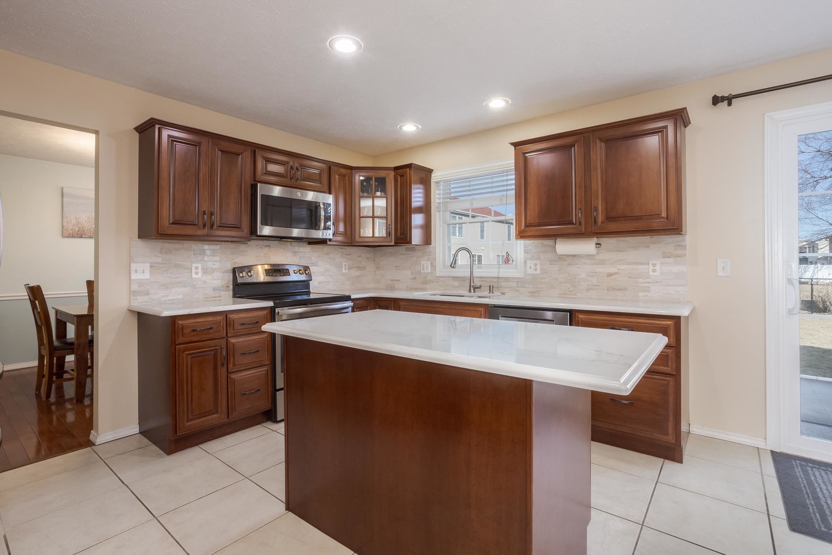 2884 Three Eagles Street Normal, IL 61761 - Photo 10 of 48 a kitchen with stainless steel appliances granite countertop a sink stove and microwave