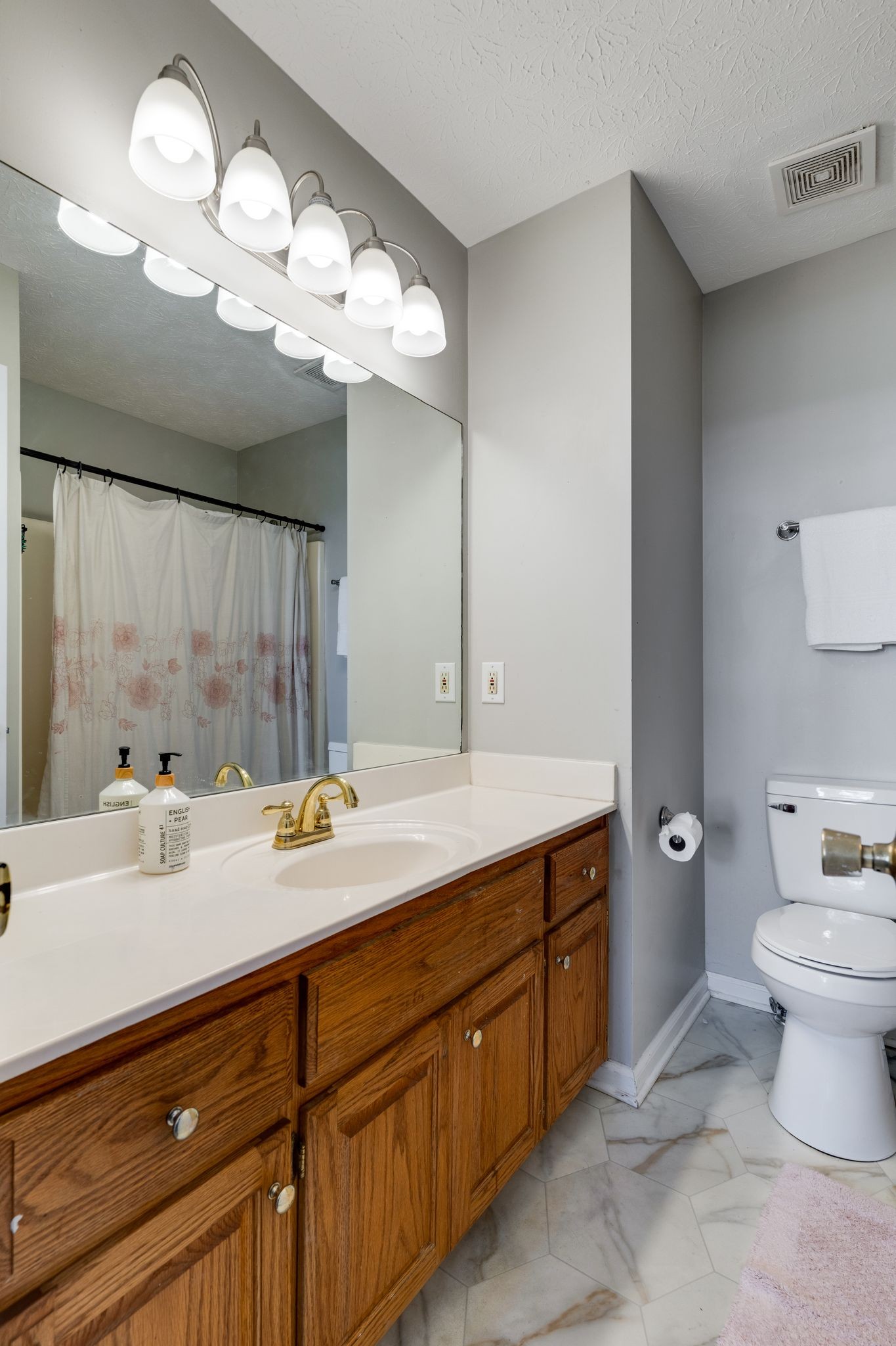 630 Portland Boulevard Portland, TN 37148 - Photo 17 of 29 a bathroom with a sink a toilet and a mirror