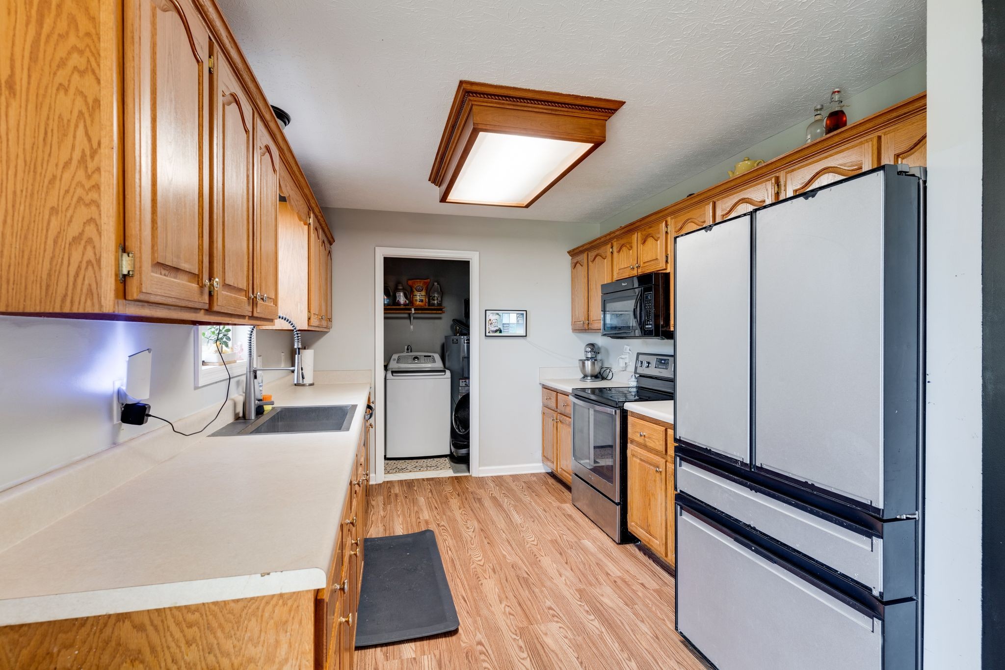 630 Portland Boulevard Portland, TN 37148 - Photo 10 of 29 a kitchen with stainless steel appliances granite countertop a refrigerator a stove top oven a sink dishwasher and wooden floor