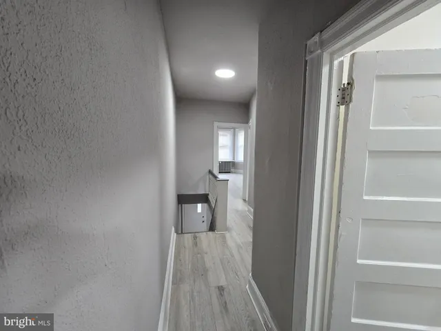 an empty room with wooden floor