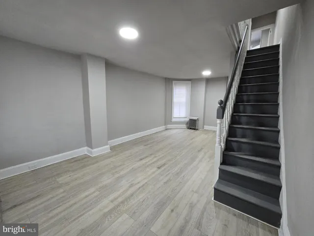 wooden floor in an empty room with stairs