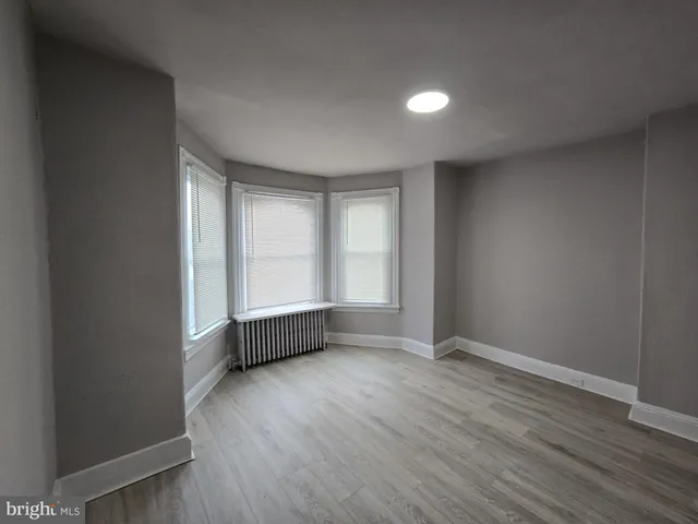 a view of an empty room and wooden floor