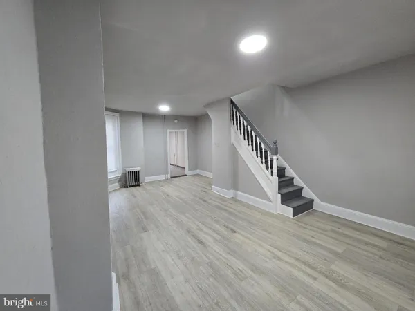 a view of an entryway with wooden floor