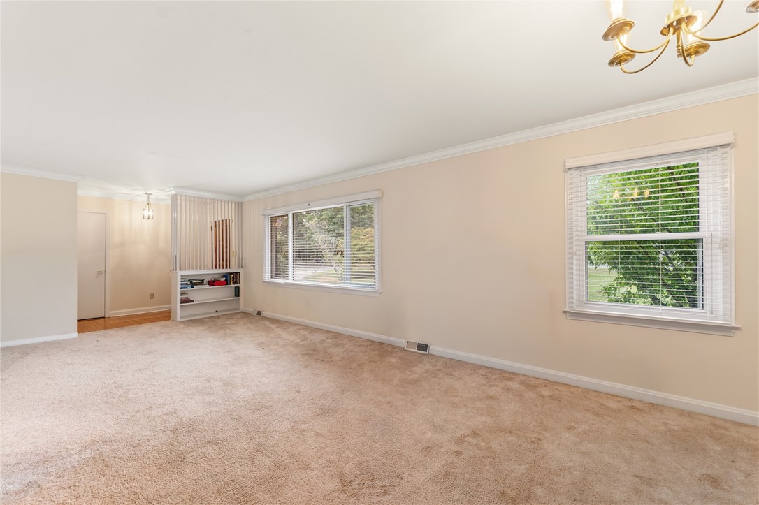 2807 Bellview Road Anderson, SC 29621 - Photo 4 of 31 Plush carpeting anchors this spacious living area beneath clean crown molding and wide windows.