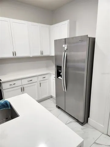 a kitchen with cabinets and stainless steel appliances