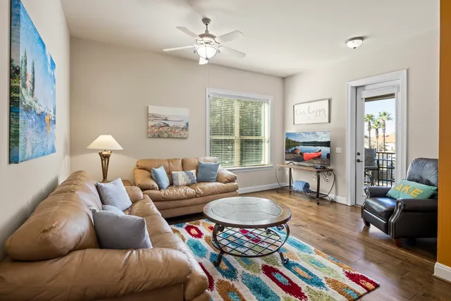 a living room with furniture a rug and a chandelier