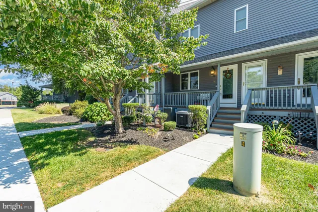 a view of a house with backyard sitting area and garden