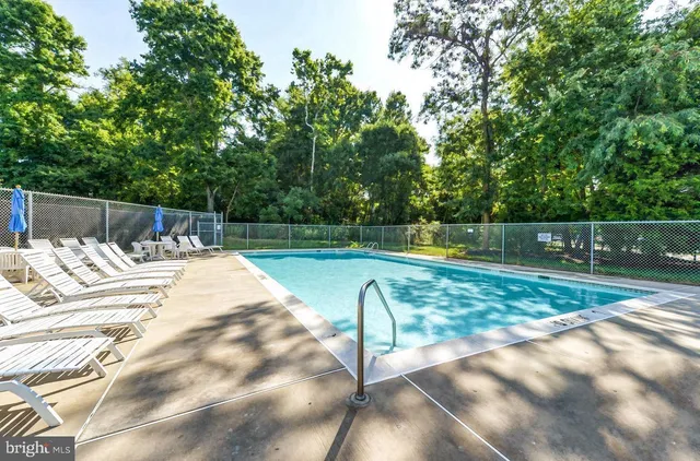 a view of swimming pool with outdoor seating and city view