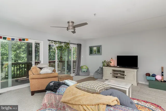 a bedroom with furniture and large windows