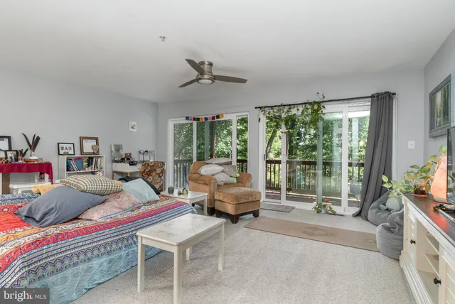 a bedroom with furniture and large windows
