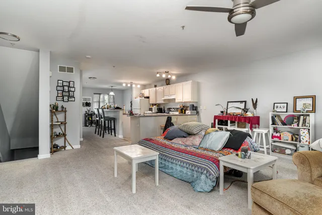 a living room with furniture and kitchen view