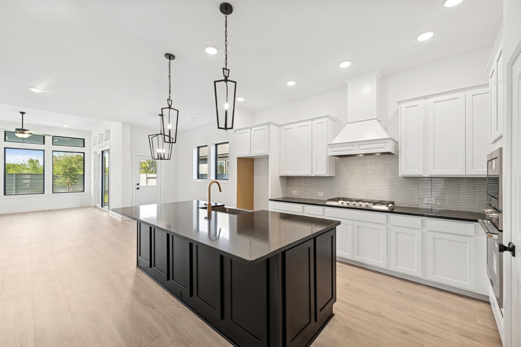 5526 Orangery Lane Manvel, TX 77578 - Photo 16 of 47 a kitchen with stainless steel appliances granite countertop a sink a stove and a wooden floors