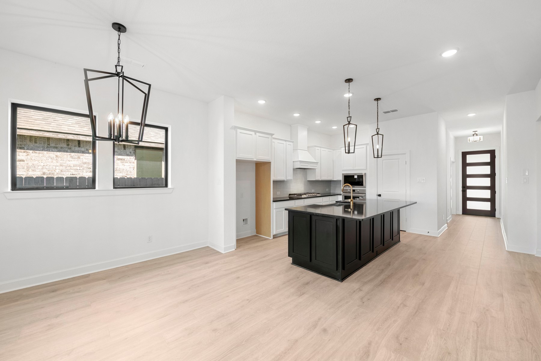 5526 Orangery Lane Manvel, TX 77578 - Photo 21 of 47 a kitchen with stainless steel appliances kitchen island granite countertop a stove and a refrigerator