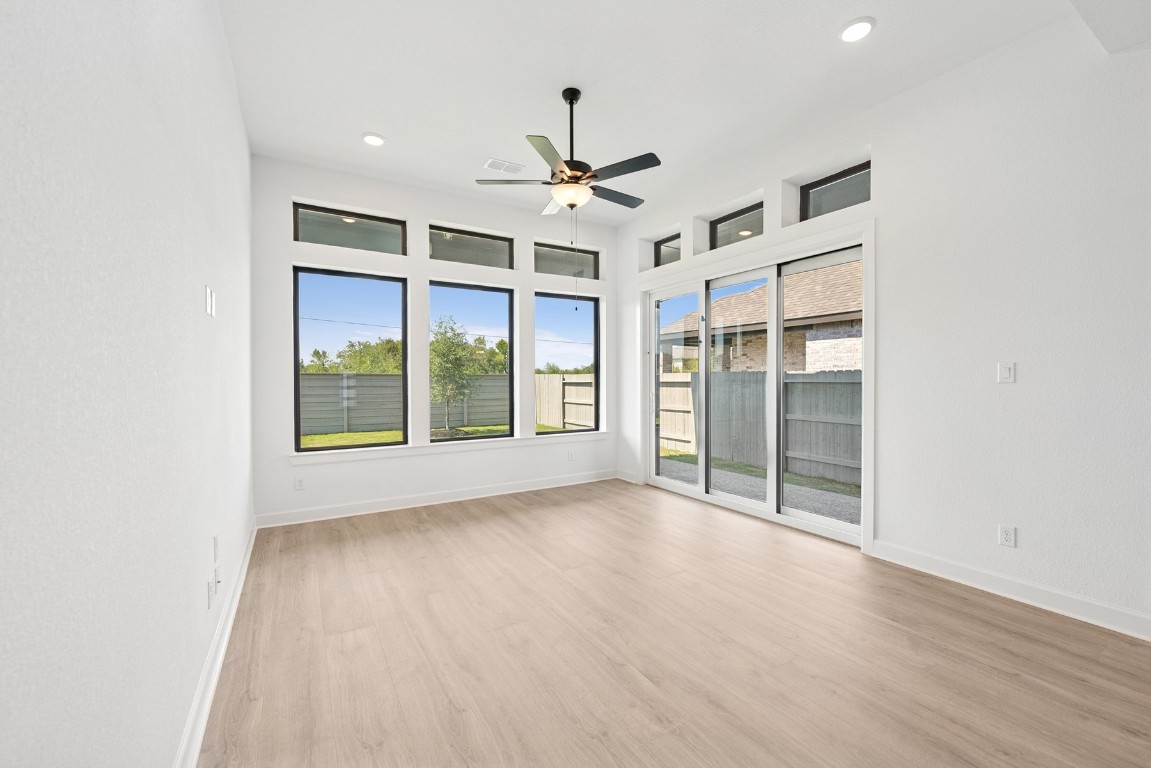 5526 Orangery Lane Manvel, TX 77578 - Photo 23 of 47 en empty room with windows and ceiling fan