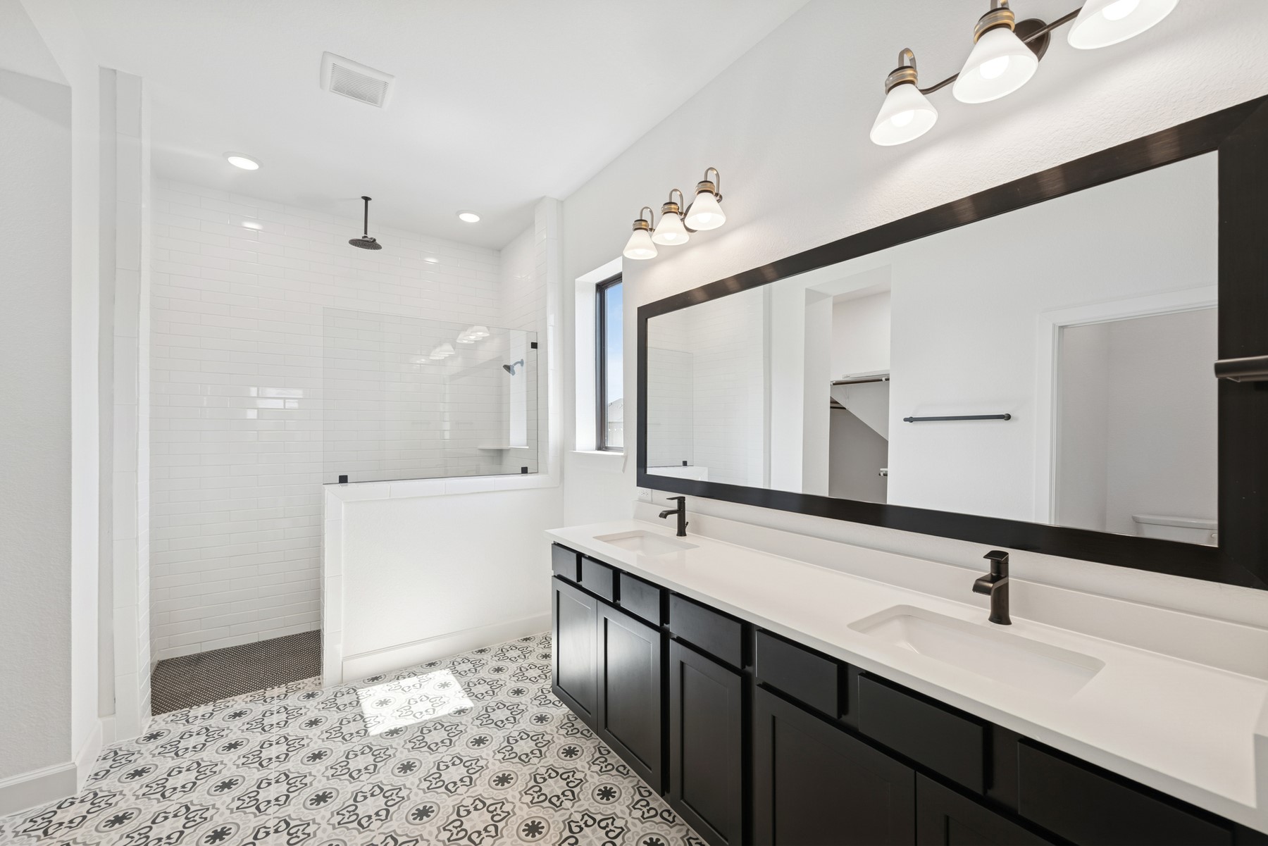 5526 Orangery Lane Manvel, TX 77578 - Photo 28 of 47 a spacious bathroom with a double vanity sink and a mirror