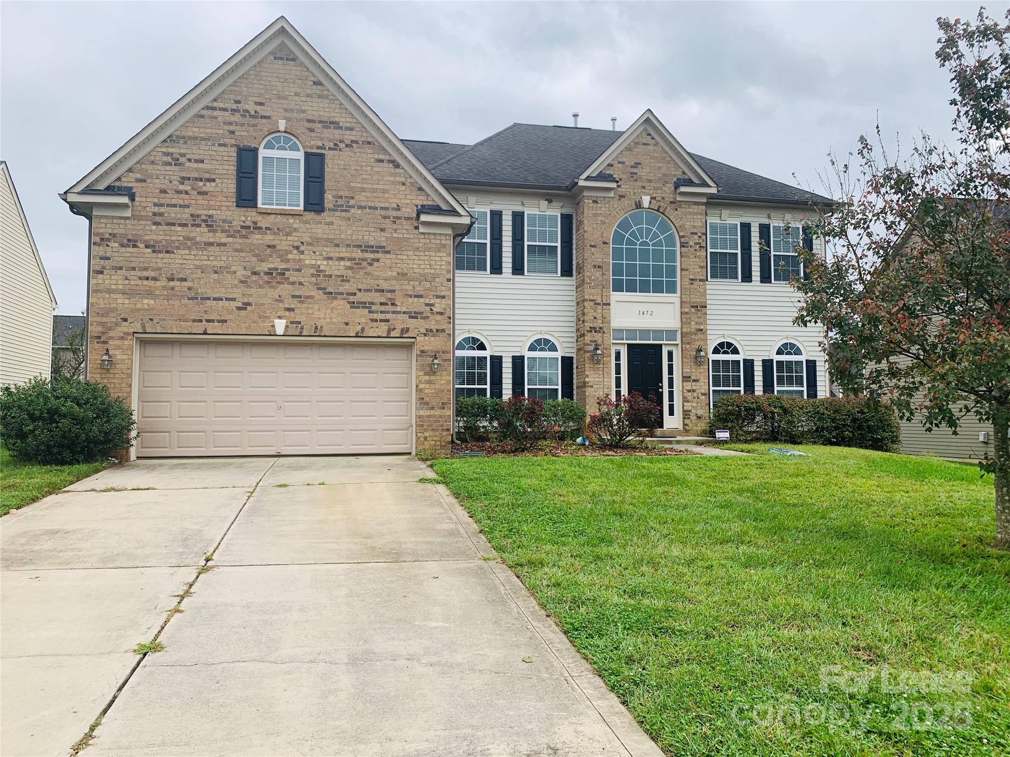 1472 Chandler Avenue Northwest Concord, NC 28027 - Photo 1 of 21 a front view of a house with a yard and garage