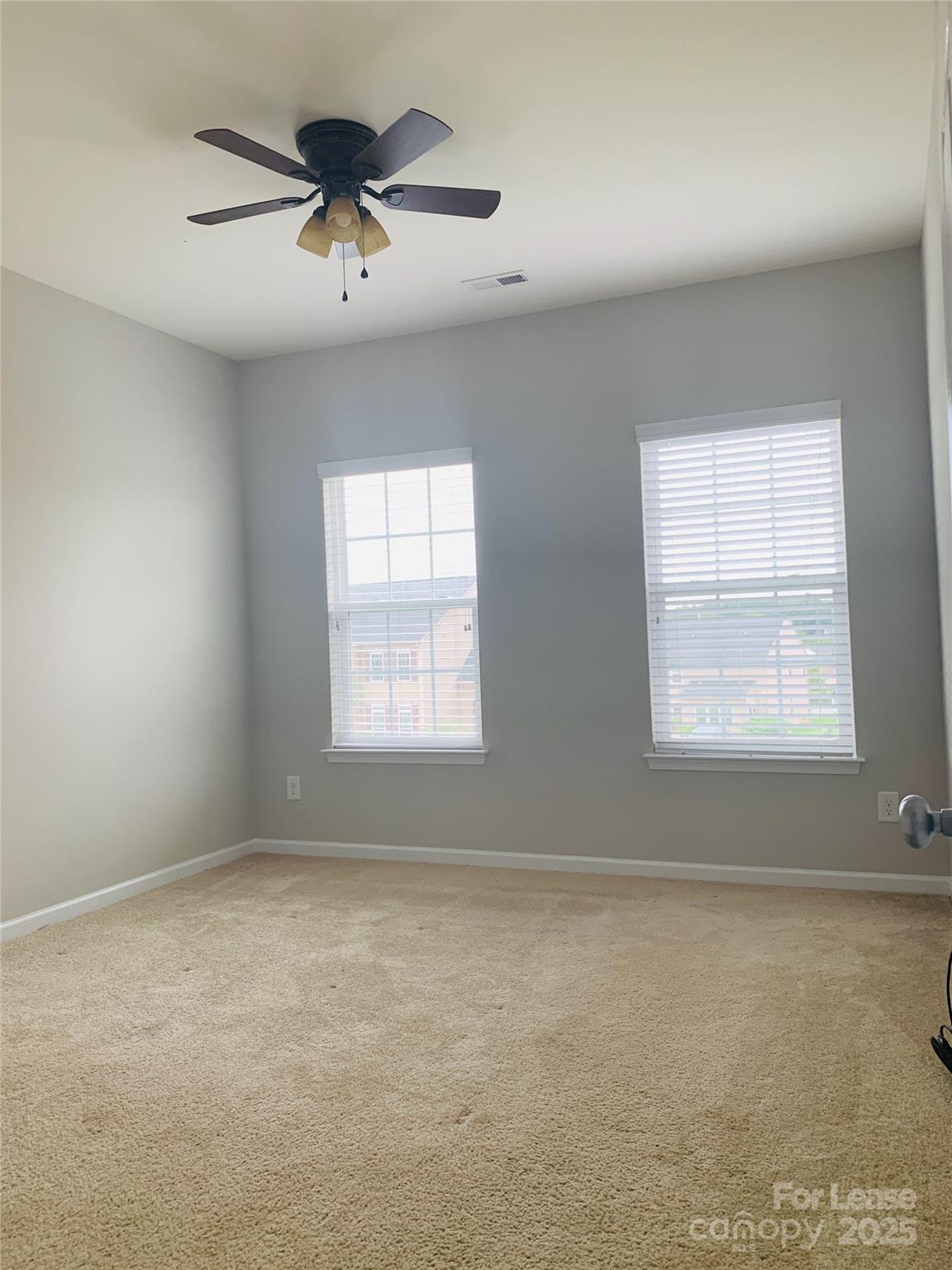 1472 Chandler Avenue Northwest Concord, NC 28027 - Photo 16 of 21 an empty room with a window and a ceiling fan