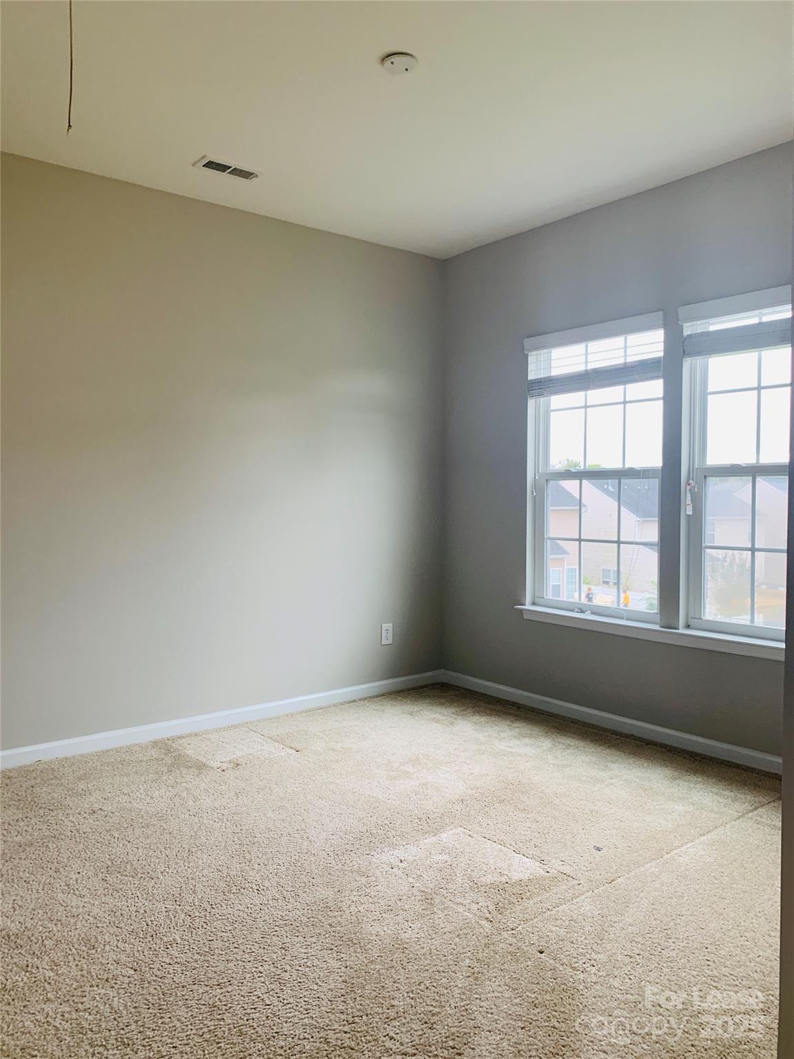 1472 Chandler Avenue Northwest Concord, NC 28027 - Photo 18 of 21 wooden floor in an empty room with a window