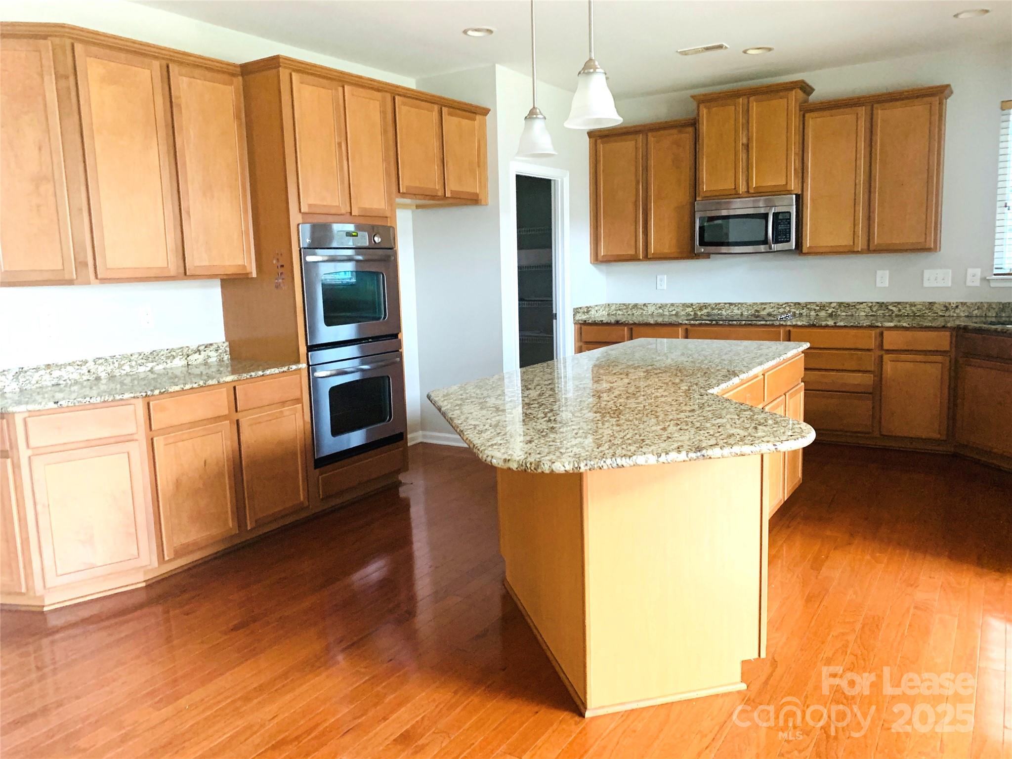 1472 Chandler Avenue Northwest Concord, NC 28027 - Photo 5 of 21 a kitchen with stainless steel appliances granite countertop a sink refrigerator and microwave