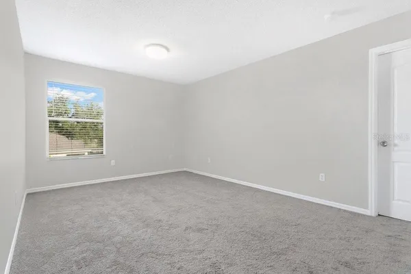 a bathroom with a granite countertop toilet sink and mirror
