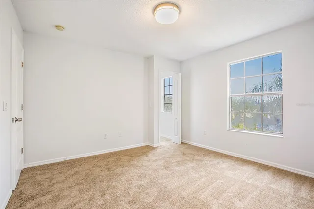 an empty room with windows and closet