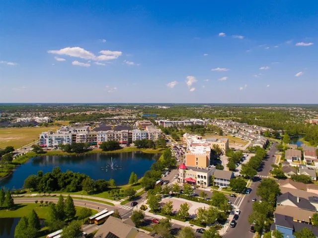 a view of a city with lots of residential buildings ocean and mountain view